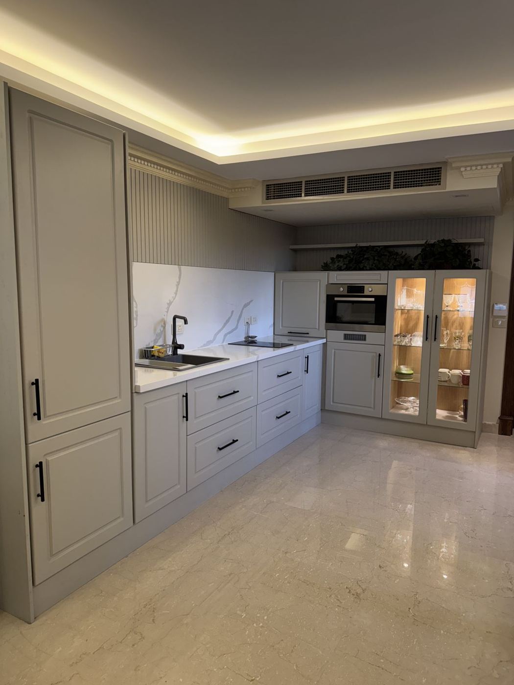 Light grey classic kitchen with tall pantry units