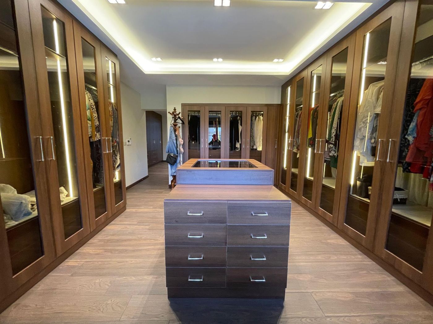Walnut walk-in dressing room with glass doors