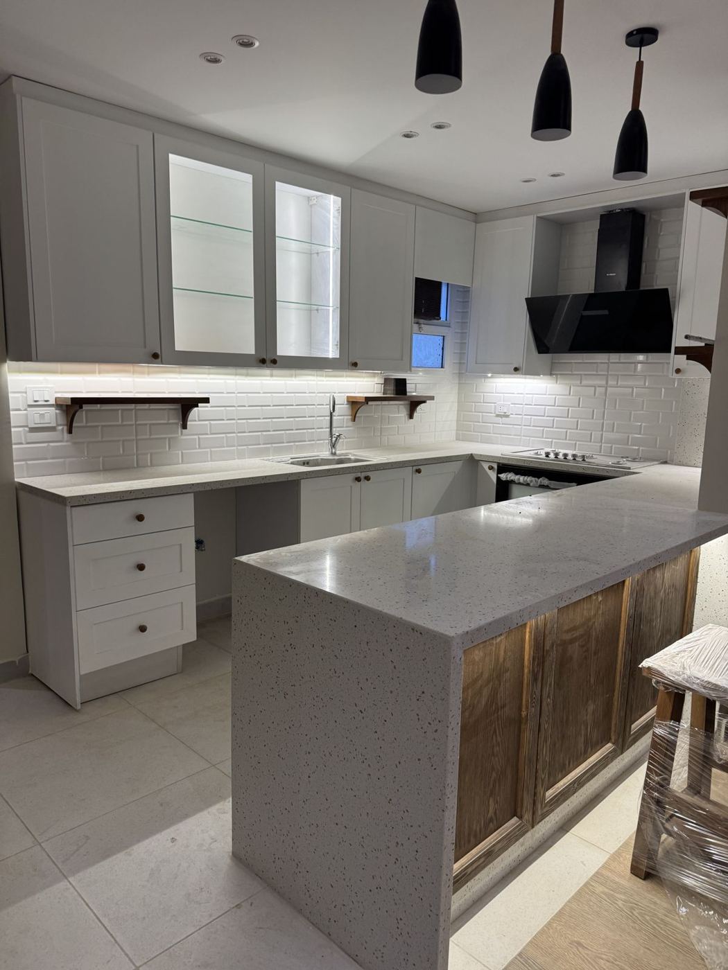 White kitchen with pendant lights and breakfast counter