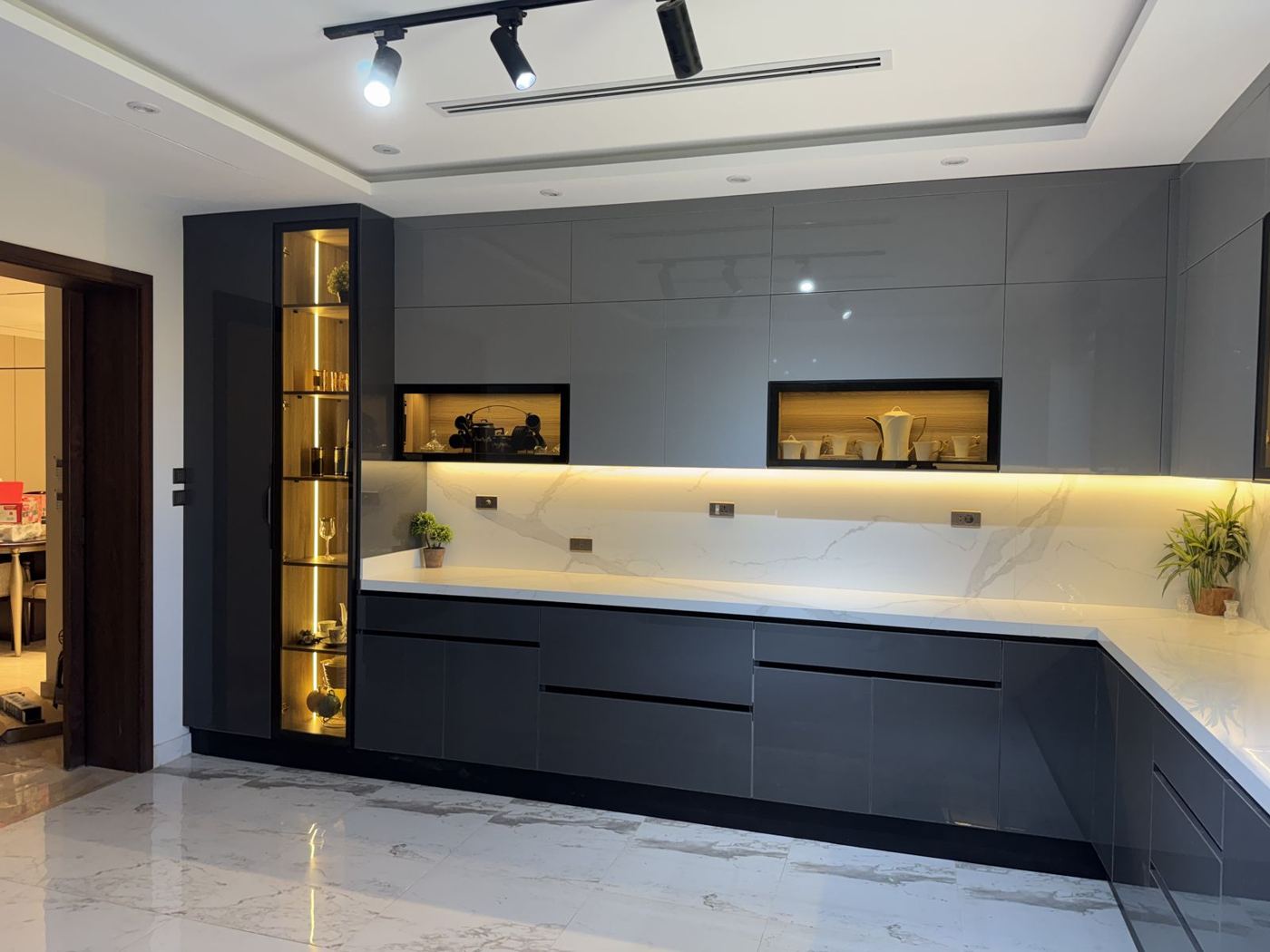 Grey gloss kitchen with lit open niches