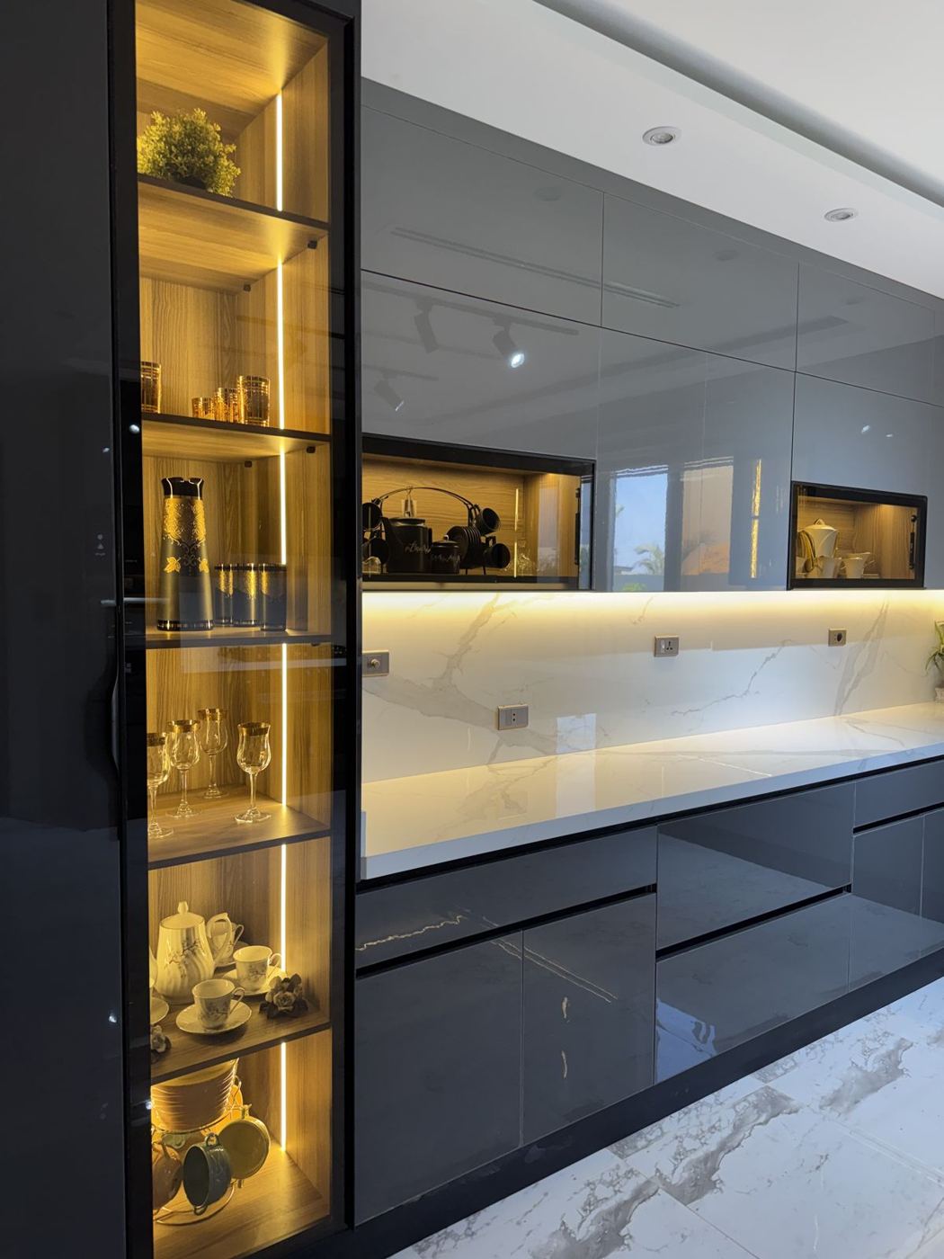 Dark gloss kitchen with lit glass display cabinet