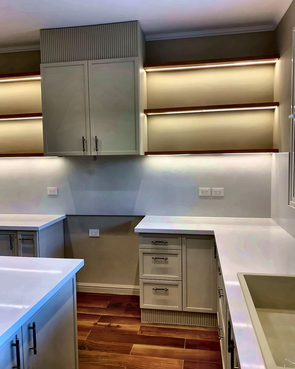 Shaker drawers and quartz worktops with lit shelves above, New Giza